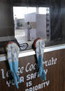 Nurse Shimray Wungreichon, 43, is reflected on the glass of a booth earlier used for collecting samples to test for COVID-19, at the District Hospital in Ukhrul, in the northeastern Indian state of Manipur, Friday, Jan. 15, 2021. Wungreichon was among the first of many Indian health workers to be vaccinated on Saturday, opening a new chapter in the battle against the pandemic in the world's second hardest-hit country, which has been scarred profoundly by a virus that has killed more than 152,000 of its people. “I am very positive about it," said Wungreichon, a nurse for 14 years who described getting vaccinated as a “normal routine” for her. (AP Photo/Yirmiyan Arthur)