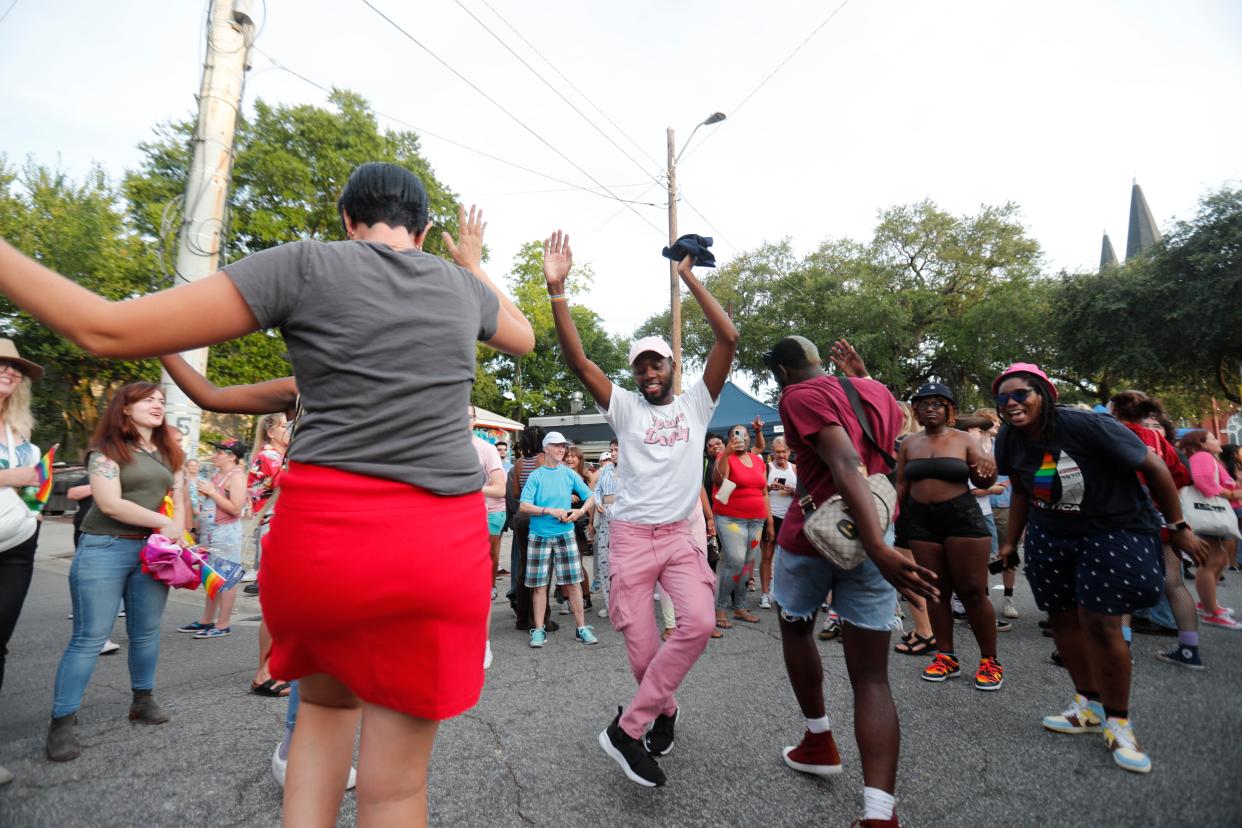 Participants dance in Bull Street Saturday during the FCPC Stonewall Anniversary Block Party.