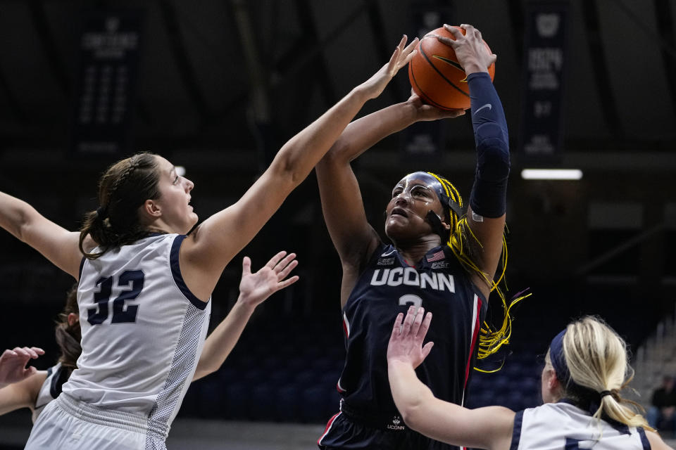 UConn forward Aaliyah Edwards (3) shoots over Butler forward Sydney Jaynes (32) during the second half of an NCAA college basketball game in Indianapolis, Tuesday, Jan. 3, 2023. (AP Photo/Michael Conroy)
