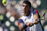 Carlos Alcaraz, of Spain, returns a shot to Andy Murray, of Britain, at the BNP Paribas Open tennis tournament Sunday, Oct. 10, 2021, in Indian Wells, Calif. (AP Photo/Mark J. Terrill)