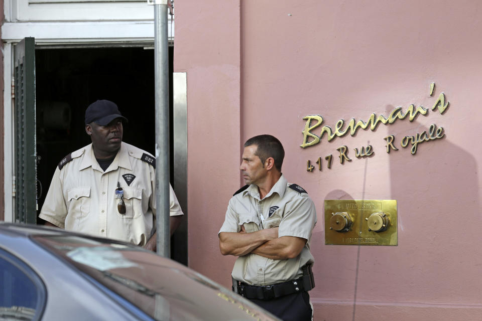 FILE - In this June 28, 2013, file photo, security guards stand in front of the now-closed Brennan's Restaurant in New Orleans. Brennan’s Restaurant: “A New Orleans Tradition Since 1946,” as the website brags, is closed, the latest shoe to fall in 40 years of headline-grabbing family discord and costly litigation over matters of control, money and use of the family name at some of the establishments that trace their lineage to Owen Sr. (AP Photo/Gerald Herbert, File)