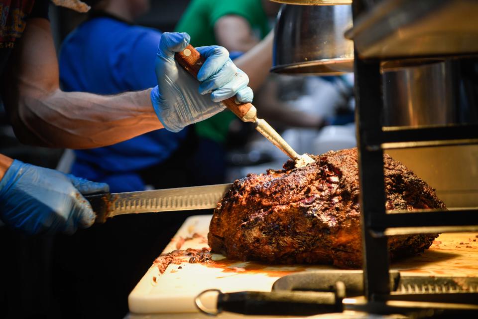 Franz Arnold cuts the roast beef to serve to customers Thursday, Jan. 5, 2023, at the family's meat-and-three Arnold's Country Kitchen in Nashville, Tenn. 