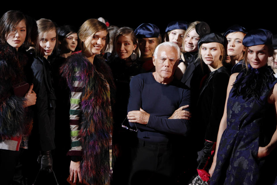 Italian fashion designer Giorgio Armani poses with his models at the end of the Emporio Armani women's Fall-Winter 2012-2013 collection that was presented in Milan, Italy, Saturday, Feb. 25, 2012.(AP Photo/Luca Bruno)