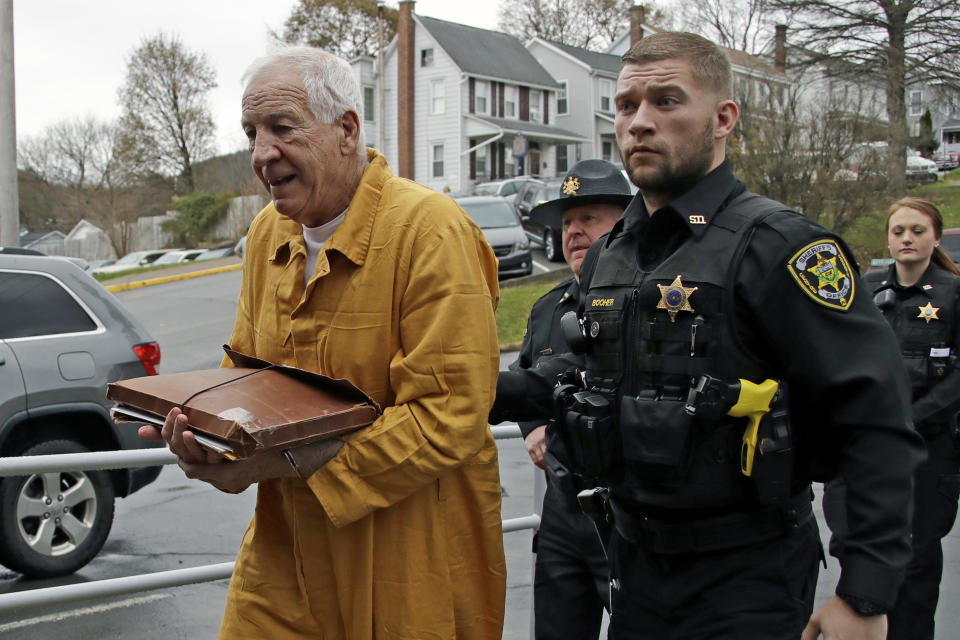 Former Penn State University assistant football coach Jerry Sandusky, left, arrives at the Centre County Courthouse for resentencing on his conviction of 45 counts of child sexual abuse Friday, Nov. 22, 2019, in Bellefonte, Pa. Sandusky was convicted in 2012 and sentenced to 30 to 60 years. (AP Photo/Gene J. Puskar)