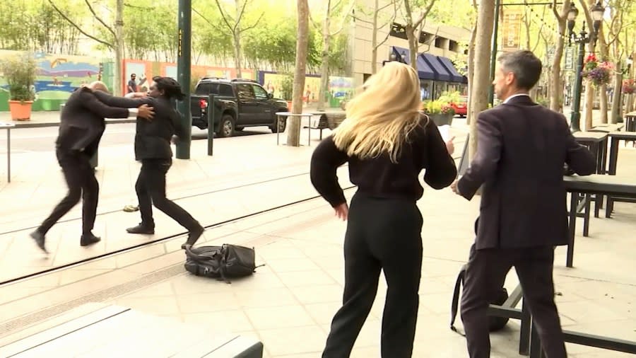 The mayor of San Jose, far right, watches his security guard fight a man downtown on April 23, 2024. (KRON4 Photo)