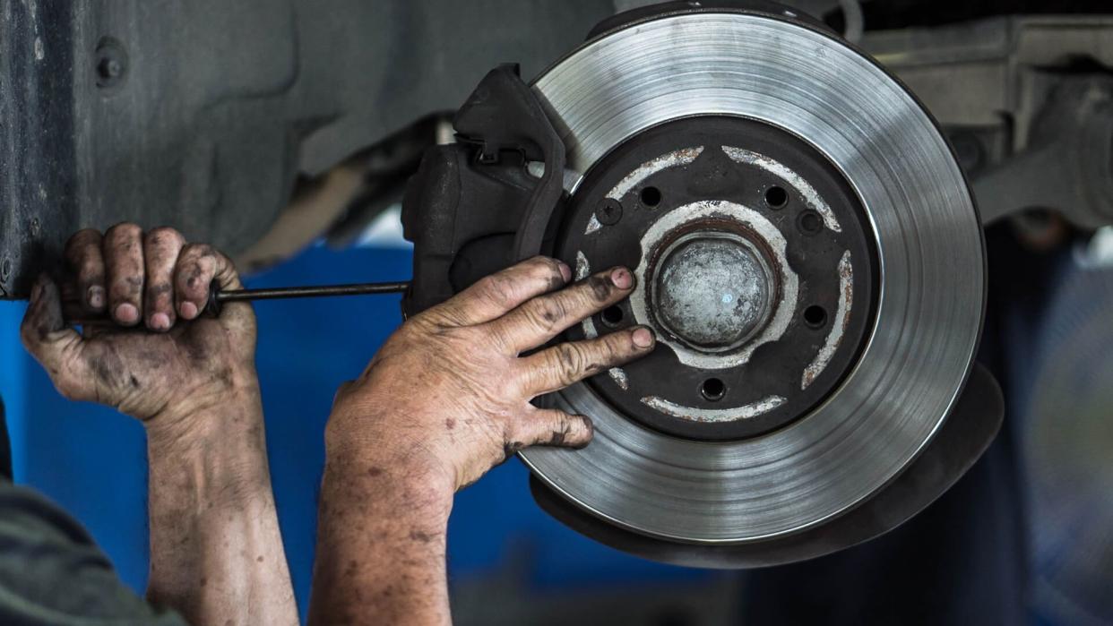 mechanic repairing brakes