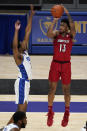 Louisville's David Johnson (13) shoots as Pittsburgh's Femi Odukale (2) defends during the second half of an NCAA college basketball game, Tuesday, Dec. 22, 2020, in Pittsburgh. (AP Photo/Keith Srakocic)