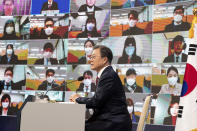 South Korean President Moon Jae-in speaks during an on-line New Year press conference with local and foreign journalists at the Presidential Blue House in Seoul, South Korea Monday, Jan. 18, 2021. (Jeon Heon-kyun/Pool Photo via AP)