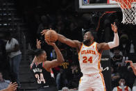 Portland Trail Blazers forward Jabari Walker (34) has his shot blocked by Atlanta Hawks forward Bruno Fernando (24) during the first half of an NBA basketball game Wednesday, March 27, 2024, in Atlanta. (AP Photo/John Bazemore)