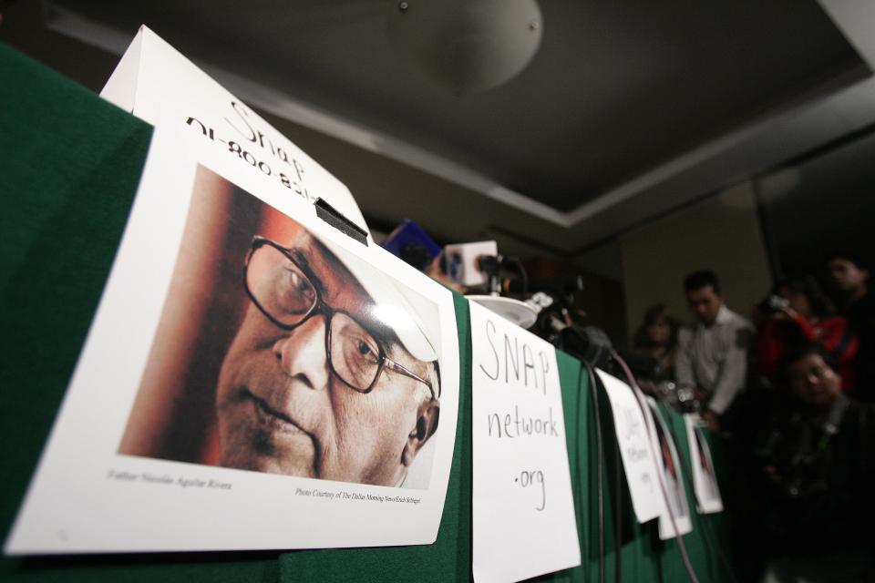 FILE - This Sept. 20, 2006 file photo shows a picture of priest Nicolas Aguilar during a news conference to announce a lawsuit against members of the Roman Catholic church in Mexico City. The Roman Catholic Archdiocese of Los Angeles will pay $13 million to settle 17 clergy abuse lawsuits, including 11 that involve Aguilar who fled prosecution and remains a fugitive more than 25 years later, plaintiffs' attorneys said Tuesday Feb. 18, 2014. (AP Photo/Gregory Bull,File)