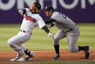 Cleveland Indians' Jose Ramirez, left, is safe at second base with a double as New York Yankees' DJ LeMahieu is late on the tag in the first inning of a baseball game, Thursday, April 22, 2021, in Cleveland. (AP Photo/Tony Dejak)