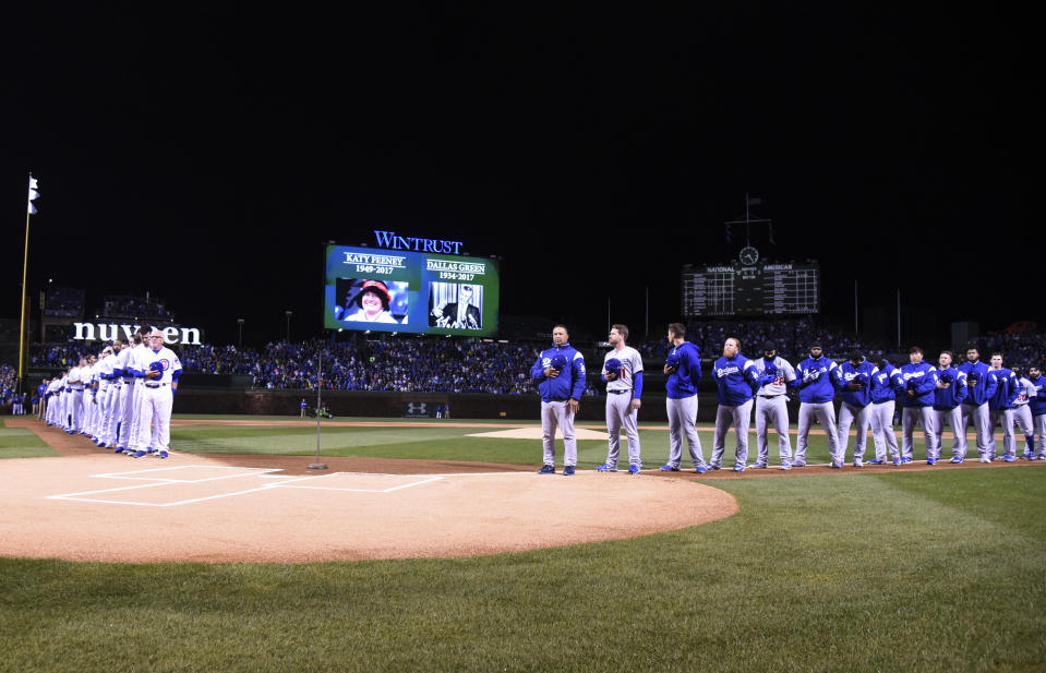 Players stand on the field during introductions before a baseball game between the Chicago Cubs and the Los Angeles Dodgers on a home opening day, Monday, April 10, 2017, in Chicago. (AP Photo/David Banks)