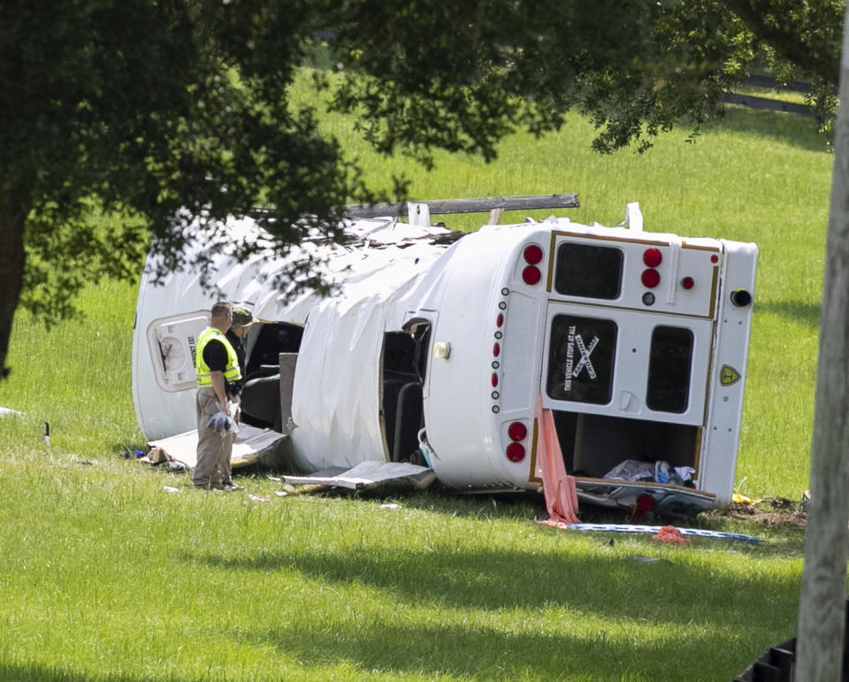 Authorities work at the scene of a deadly crash after a bus carrying farmworkers collided with a pickup truck on State Road 40 Tuesday, May 14, 2024, near Dunnellon, Fla. (AP Photo/Alan Youngblood)