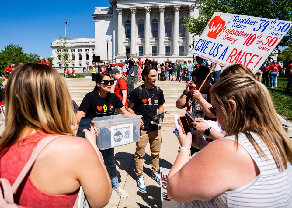(Center) Hallie Schmeling, South Milwaukee High School alternative education teacher, speaks with other educators at the Wisconsin Education Association Council's rally to support Governor Evers’ Education Budget on Saturday May 20, 2023 at the Wisconsin State Capitol in Madison, Wis.