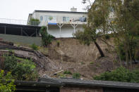A mudslide scarred hillside is shown in the backyard of a home, Tuesday, Feb. 6, 2024, in the Baldwin Hills area of Los Angeles. The mudslide occurred early Monday morning, Feb. 5. (AP Photo/Damian Dovarganes)