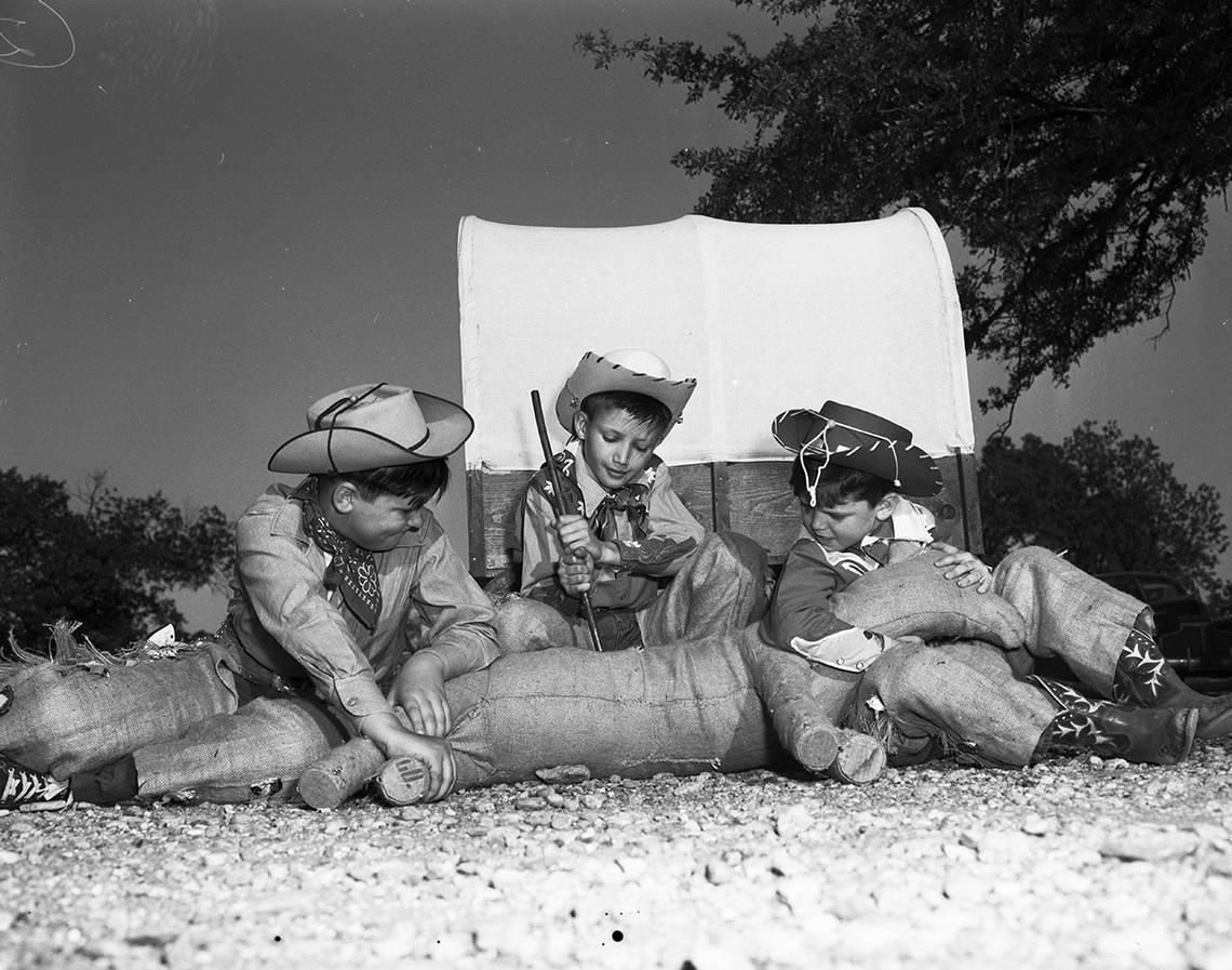 April 25, 1950: Cub Scouts in the cowboy scene of the annual Boy Scout Circus apply the branding iron to a “dogie” in front of their miniature chuck wagon. Left to right are Don Cole, Jimmy Hartman and Eddie MacConnell, all of Cub Pack 66. Fort Worth Star-Telegram archive/UT Arlington Special Collections