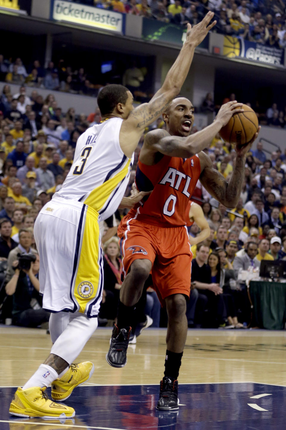 Atlanta Hawks' Jeff Teague (0) drives toward the basket as Indiana Pacers' George Hill (3) defends during the first half in Game 5 of an opening-round NBA basketball playoff series Monday, April 28, 2014, in Indianapolis. (AP Photo/Darron Cummings)