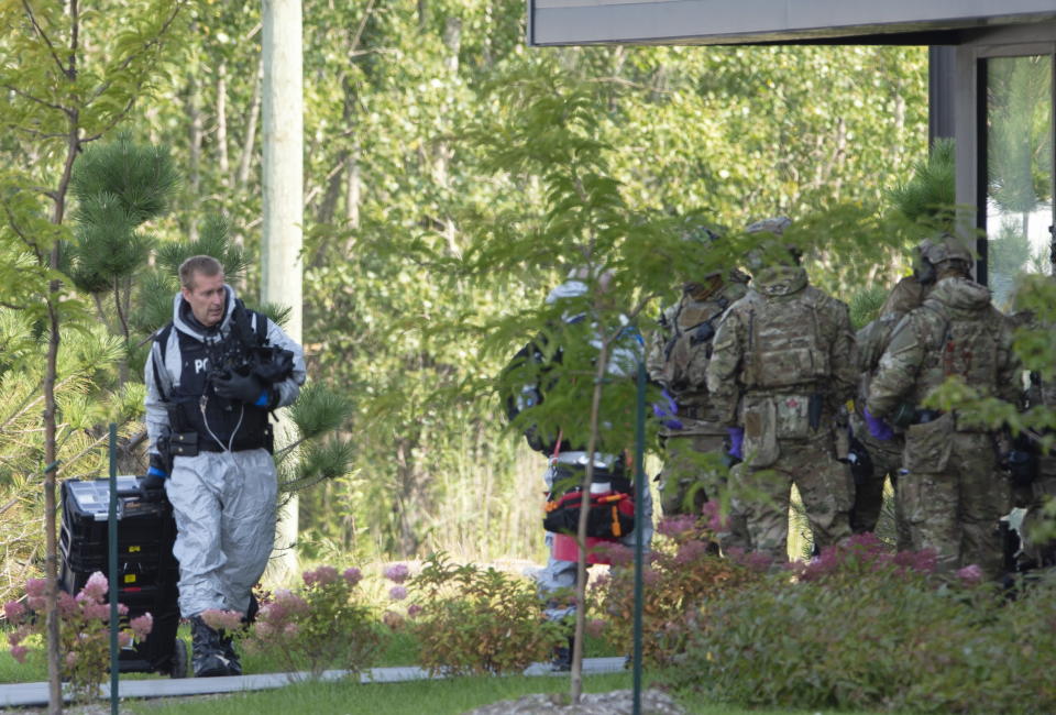 RCMP officers prepare to enter an apartment complex in connection with the mailing of ricin to President Trump Monday, Sept. 21, 2020 in St. Hubert, Canada. (Ryan Remiorz/The Canadian Press via AP)