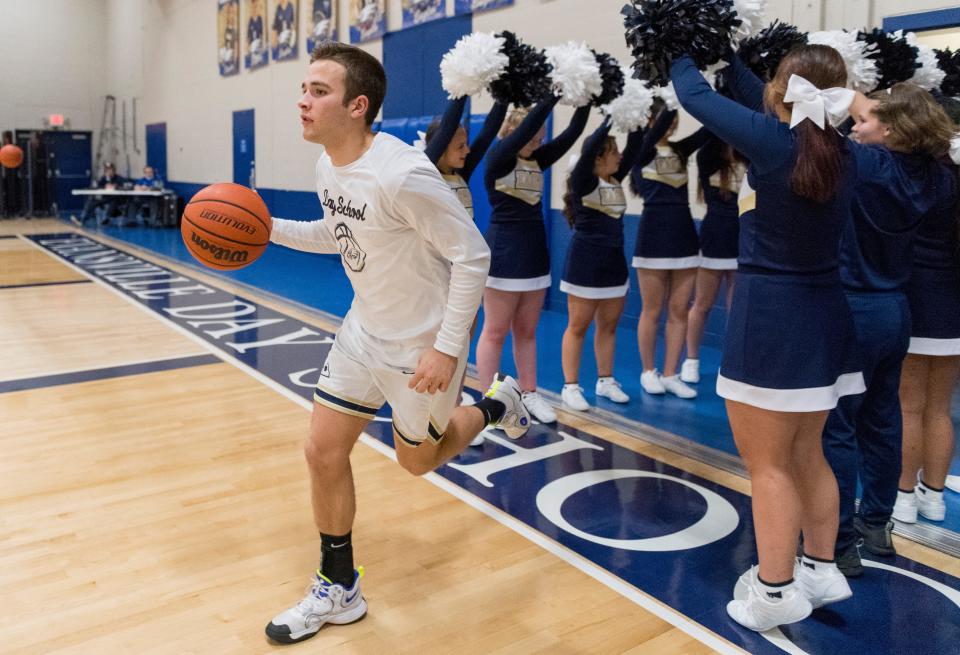 Evansville Day School’s Tyler Myers (10) leads the Eagles from the locker room ahead of their game against the South Spencer Rebels in Evansville, Ind., Tuesday evening, Jan. 11, 2022.