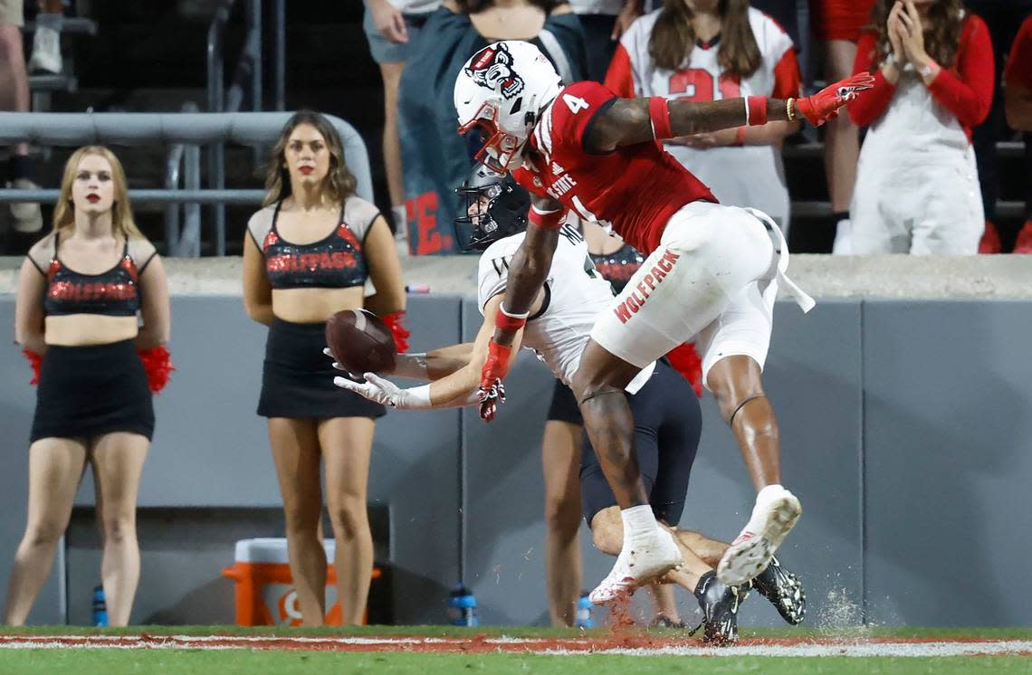 Wake Forest wide receiver Taylor Morin (2) pulls in a 24-yard touchdown reception as N.C. State safety Cyrus Fagan (4) defends during the first half of N.C. State’s game against Wake Forest at Carter-Finley Stadium in Raleigh, N.C., Saturday, Nov. 5, 2022.