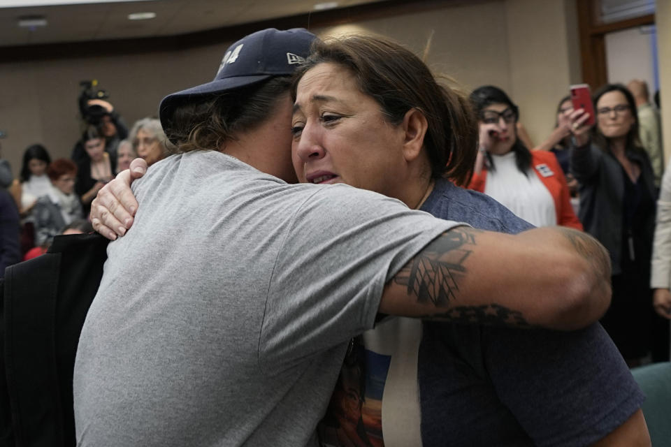 Veronica Mata, right, and other family members of the victims of the Uvalde shootings react after a Texas House committee voted to take up a bill to limit the age for purchasing AR-15 style weapons in the full House in Austin, Texas, Monday, May 8, 2023. For Mata, teaching kindergarten in Uvalde after her daughter was among the 19 students who were fatally shot at Robb Elementary School became a year of grieving for her own child while trying to keep 20 others safe. (AP Photo/Eric Gay)