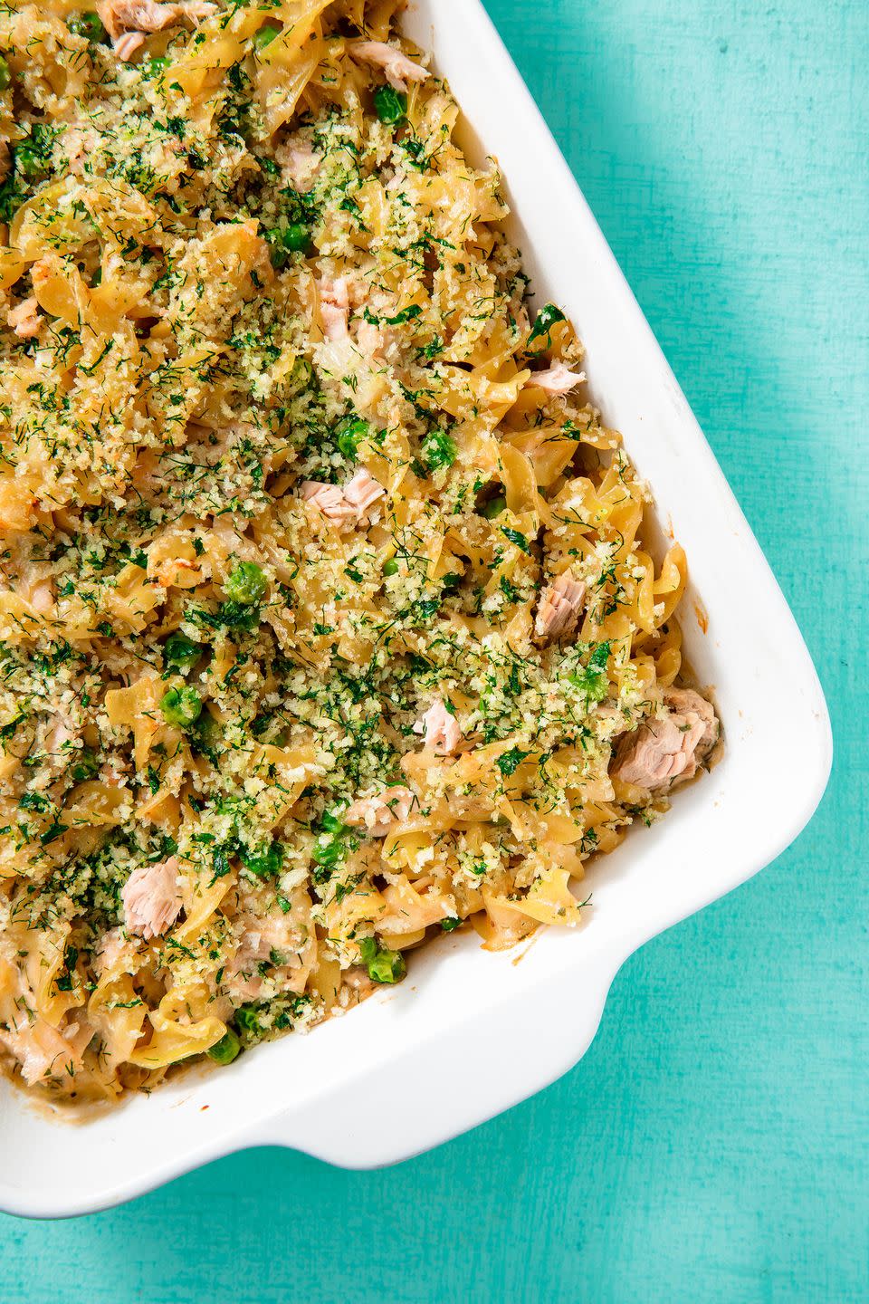 tuna casserole in a white baking dish on a teal background