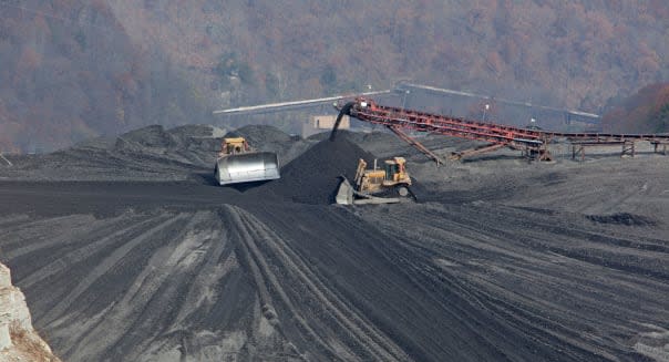 Bulldozer Spread Coal Mine Waste on Impoundment Dam
