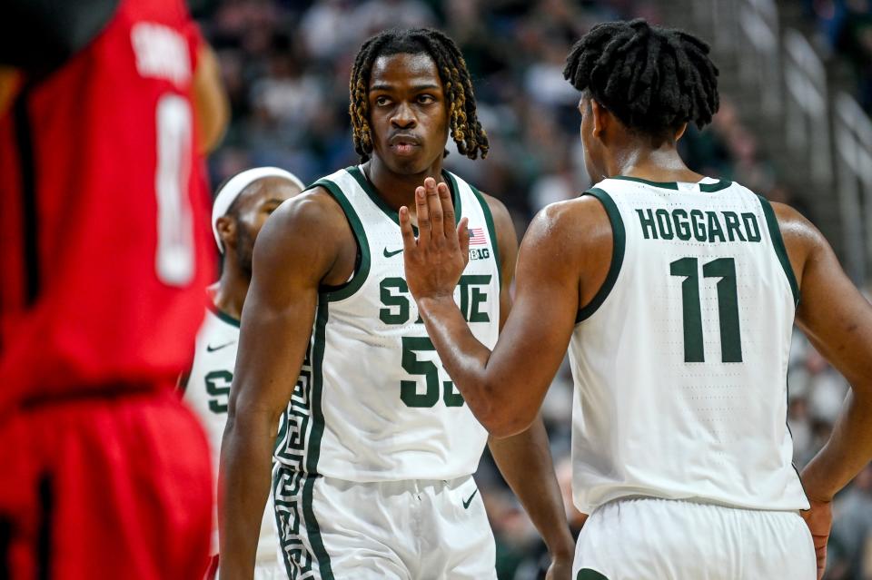 Michigan State's Coen Carr, left, goes to the line after making a shot and drawing a Rutgers foul during the second half on Sunday, Jan. 14, 2024, at the Breslin Center in East Lansing.