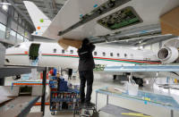 A technician works on a Bombardier Global aircraft at the company's service centre at Biggin Hill, Britain March 5, 2018. REUTERS/Peter Nicholls