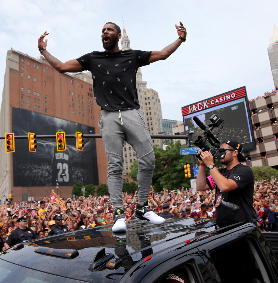 Cleveland Cavaliers Kyrie Irving celebrates the Cavaliers 2016 NBA Championship during a parade in downtown Cleveland, Ohio, U.S. June 22, 2016. REUTERS/Aaron Josefczyk