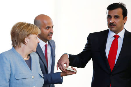 German Chancellor Angela Merkel and Qatar Emir Sheikh Tamim bin Hamad al-Thani attend a news conference in Berlin, Germany, September 15, 2017. REUTERS/Axel Schmidt