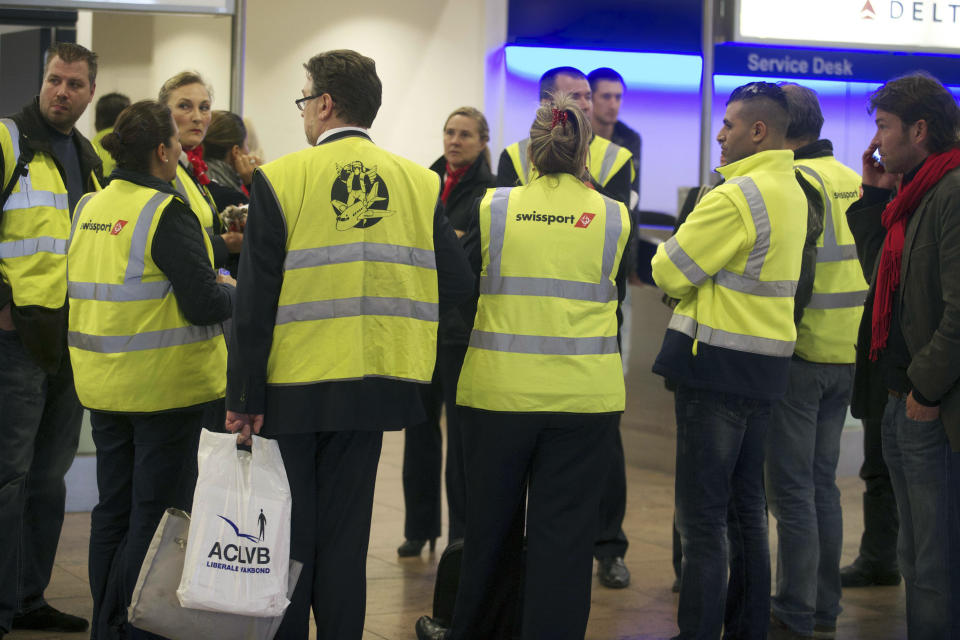 Strikong employees stand around on the second day of a strike of Swissport ground and cargo service at Brussels national airport in Zaventem,on May 14, 2013. AFP PHOTO/ NICOLAS MAETERLINCK        (Photo credit should read NICOLAS MAETERLINCK/AFP via Getty Images)