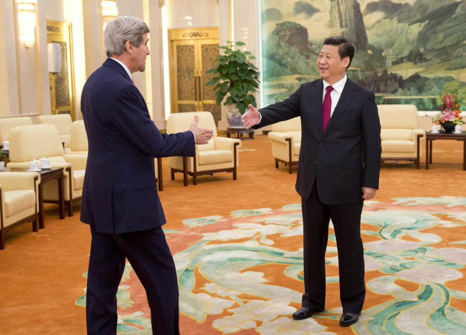 U.S. Secretary of State John Kerry, left, is greeted by Chinese President Xi Jinping at the Great Hall of the People in Beijing, China Friday, Feb. 14, 2014. Kerry is meeting senior Chinese officials on Friday in Beijing to seek their help in bringing a belligerent North Korea back to nuclear disarmament talks. (AP Photo/Evan Vucci, Pool)