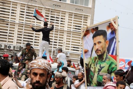 Supporters of Yemen's southern separatists carry the coffin and a picture of Brigadier General Muneer al-Yafee, killed in a Houthi missile attack, during his funeral in Aden