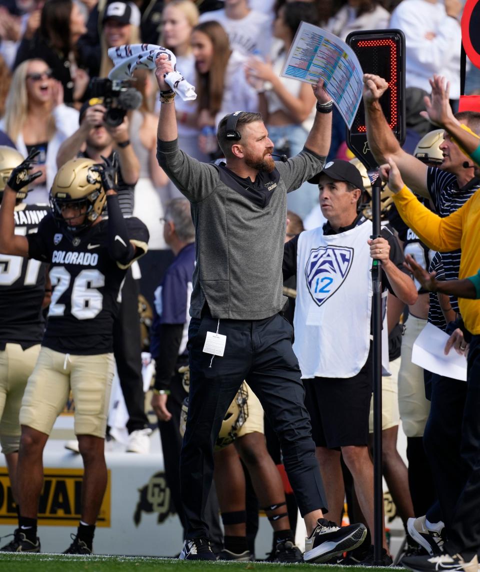 Colorado interim head coach Mike Sanford, center, exhorts the crowd in the first half of an NCAA college football game against California in Folsom Field Saturday, Oct. 15, 2022, in Boulder, Colo. (AP Photo/David Zalubowski)