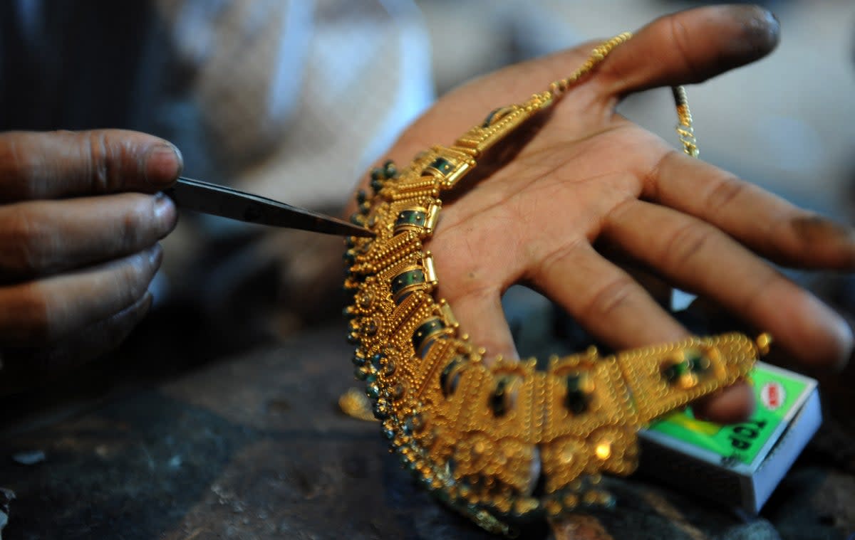 An Indian goldsmith works on jewellery at a workshop in Siliguri (AFP via Getty)