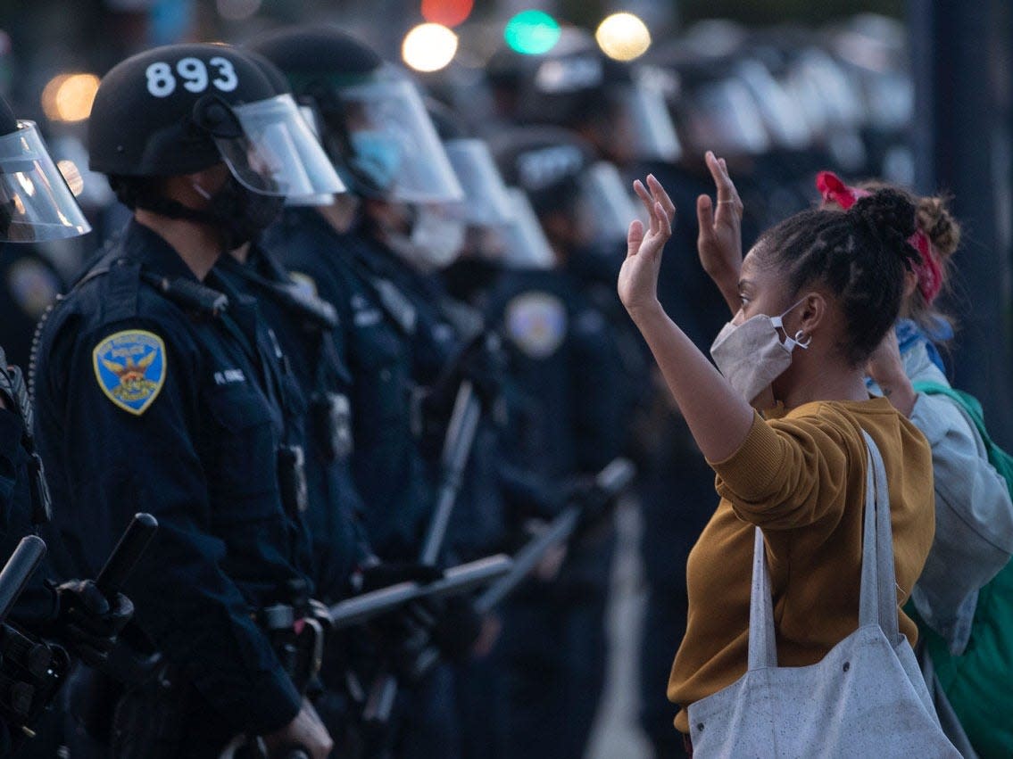 A woman faces off against San Francisco police, May 31, 2020, in California. (Karl Mondon_Digital First Media_East Bay Times via Getty Images)