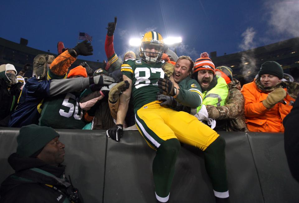 Green Bay Packers wide receiver Jordy Nelson (87) does the Lambeau Leap near Stephen Pfeil (left), of Madison and Sean Sanchez of Denver, after Nelson scored a 2nd quarter touchdown.at Lambeau Field on Sunday, January 5, 2014.