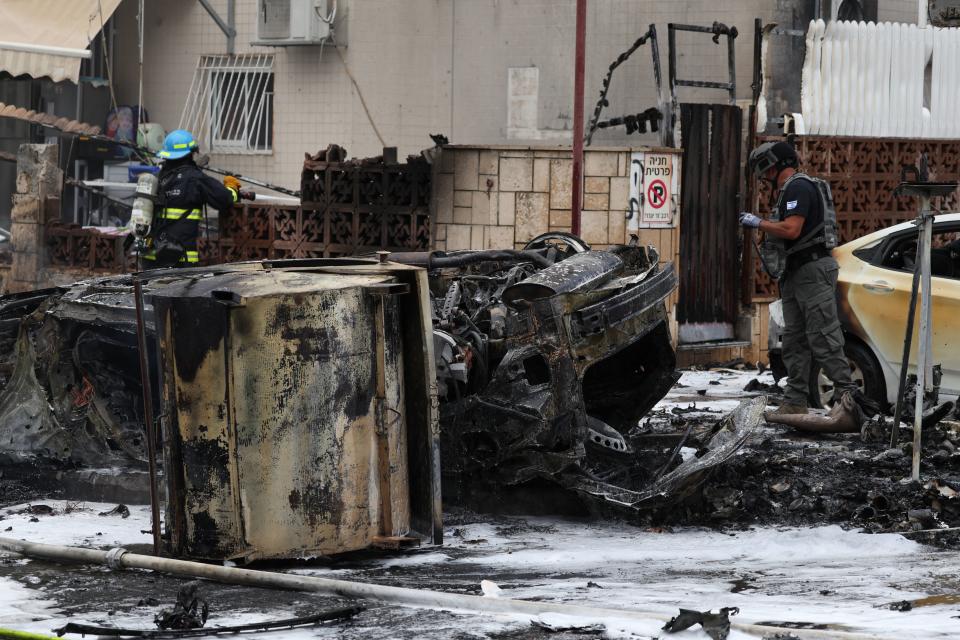 First responders inspect the site of a rocket attack in Ashdod, Israel, on Monday. (Ahmad Gharabli/AFP via Getty Images)