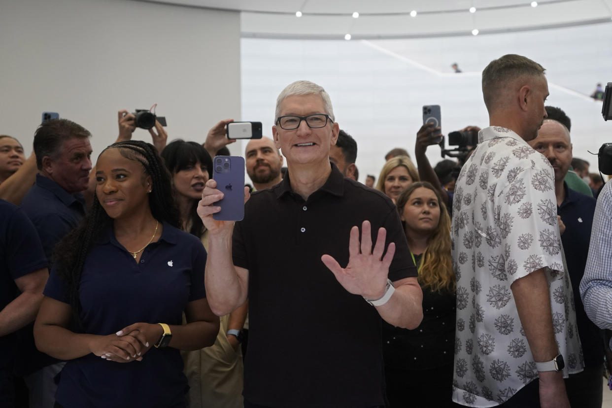 Apple CEO Tim Cook holds up an iPhone 14 Pro at an Apple event on the campus of Apple's headquarters in Cupertino, Calif., Wednesday, Sept. 7, 2022. (AP Photo/Jeff Chiu)