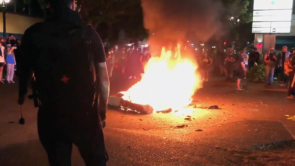 In this image taken from video a mattress burns in the street near the Portland Police Bureau's North Precinct Sunday night, Sept. 6, 2020, in Portland, Ore. Protesters have gathered for more than 100 days following the death of George Floyd in Minneapolis. (KATU Photo via AP)