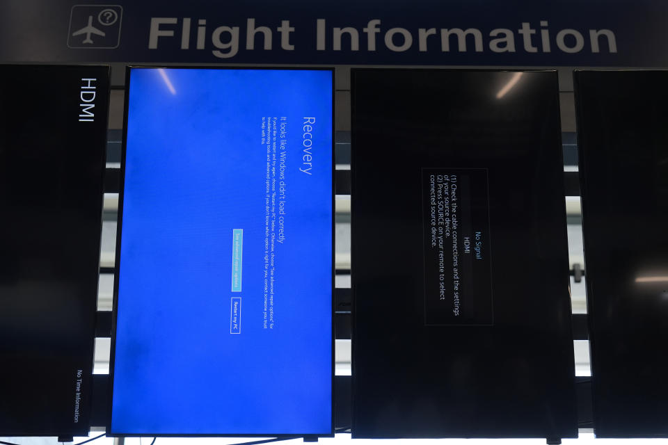 A "blue screen of death" is displayed instead of flight information at Chicago O'Hare International Airport after a software glitch caused widespread outages as reported by airlines around the world, Friday, July 19, 2024, in Chicago. (AP Photo/Erin Hooley)