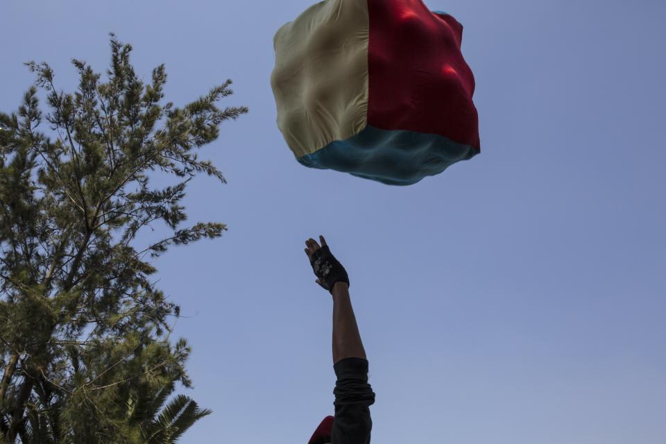 A Central American migrant plays with other colleagues with a bucket of fabrics at the Jesus Martinez stadium in Mexico City, Wednesday, Nov. 7, 2018. Central American migrants on Wednesday continued to straggle in for a rest stop at a Mexico City stadium, where about 4,500 continue to weigh offers to stay in Mexico against the desire of many to reach the U.S. border. (AP Photo/Rodrigo Abd)