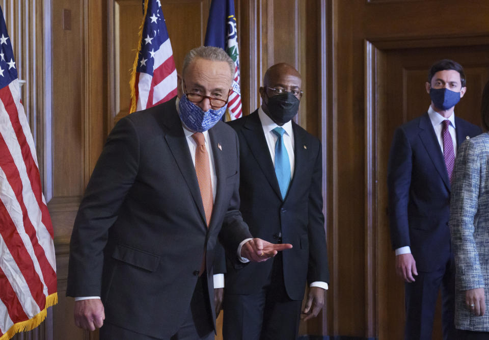 On the first full day of the Democratic majority in the Senate, Majority Leader Chuck Schumer, D-N.Y., left, is joined by Sen. Raphael Warnock, D-Ga., center, and Sen. Jon Ossoff, D-Ga., during a press event at the Capitol in Washington, Thursday, Jan. 21, 2021. The pivotal Georgia runoff election this month was decisive in handing Democrats the majority in the Senate. (AP Photo/J. Scott Applewhite)