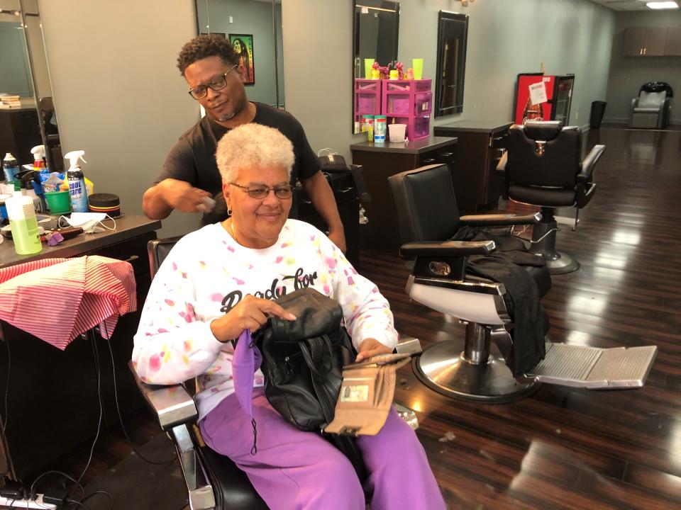 Dana Rivers cuts a patron's hair at the Clipper Zone barbershop in Stockbridge, Ga. As the nation looks ahead, “I hope we’ll start to see the ignorance and the bigotry die out,” Rivers says.