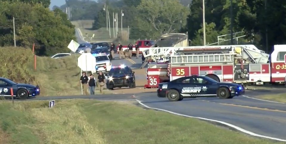 Police and emergency crews at the scene of the Viola crash. The impact of the SUV split the truck's trailer in two.