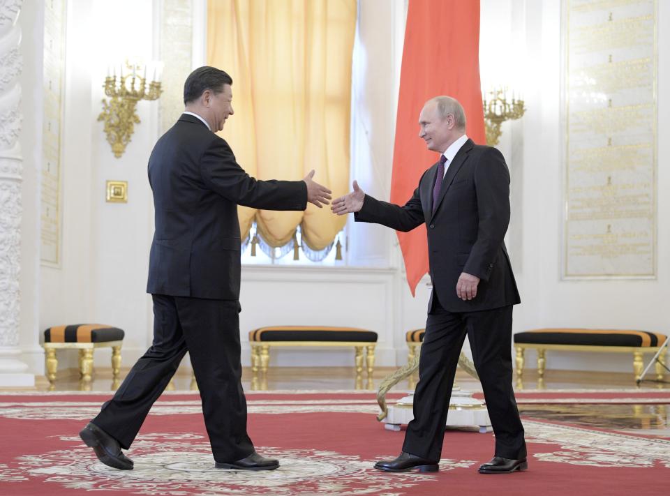 Russian President Vladimir Putin, right, greets Chinese President Xi Jinping during welcome ceremony prior to their talks in the Kremlin in Moscow, Russia, Wednesday, June 5, 2019. Chinese President Xi Jinping is on visit to Russia this week and is expected to attend Russia's main economic conference in St. Petersburg. (Alexei Druzhinin, Sputnik, Kremlin Pool Photo via AP)