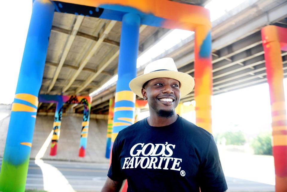 Artist KaDavien Baylor stands near a mural he completed at the Ascension Underpass in downtown Shreveport, Louisiana in 2022. Baylor was selected to commission a mural for the Quincy Square project in downtown Bremerton, intended for one side of the city's parking garage at Fourth Street and Washington Avenue.