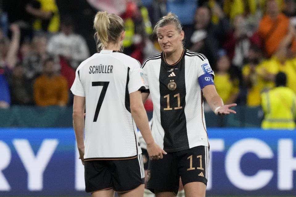 Germany's Alexandra Popp, center, gestures to teammate Lea Schueller while Colombia players celebrate at the end of the Women's World Cup Group H soccer match between Germany and Colombia at the Sydney Football Stadium in Sydney, Australia, Sunday, July 30, 2023. Colombia won 2-1. (AP Photo/Mark Baker)