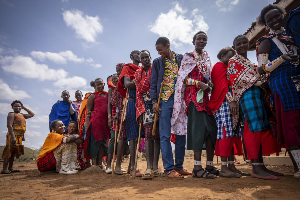 Maasai wait in line to cast their votes at a polling station at Niserian Primary School, in Kajiado County, Kenya Tuesday, Aug. 9, 2022. Polls opened Tuesday in Kenya's unusual presidential election, where a longtime opposition leader who is backed by the outgoing president faces the deputy president who styles himself as the outsider. (AP Photo/Ben Curtis)